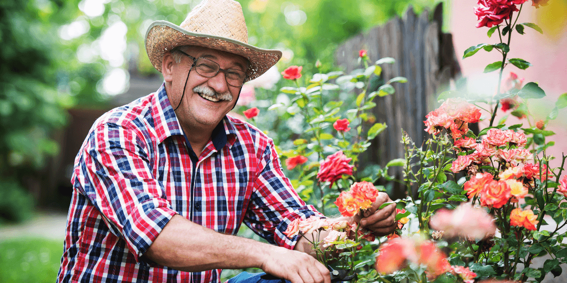 Elderly man tending to his flower garden