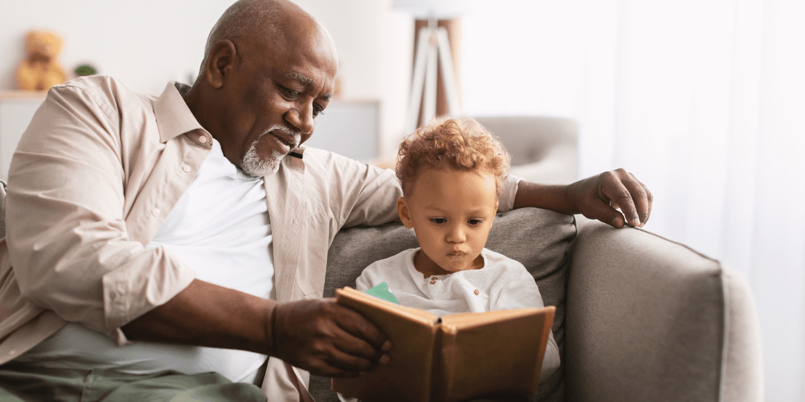 grandfather reading a book with their grandson