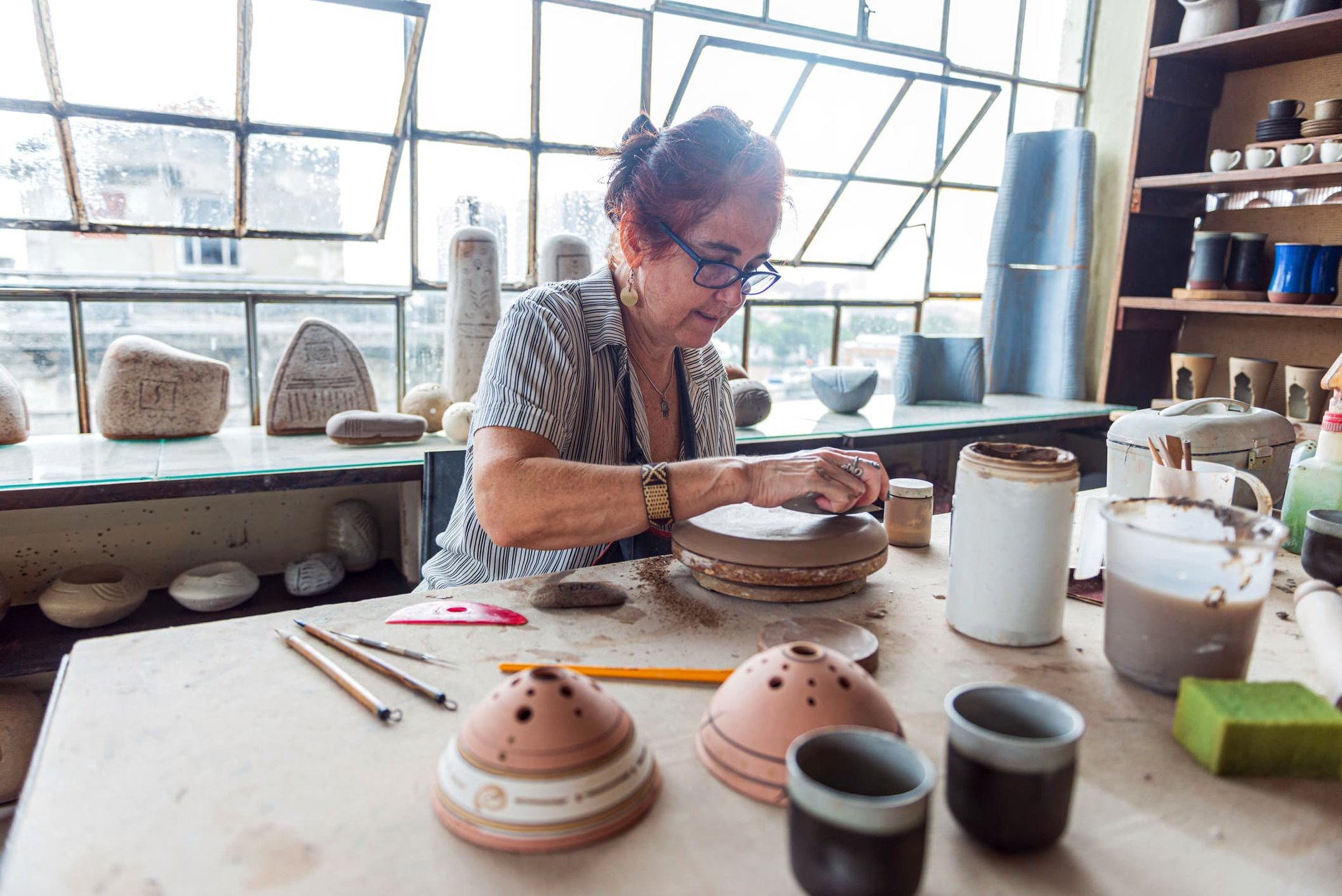 senior woman making pottery