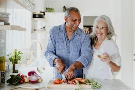 Senior couple in kitchen smiling together