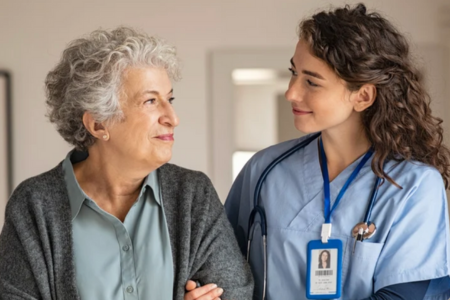 Senior woman with nurse smiling at eachother