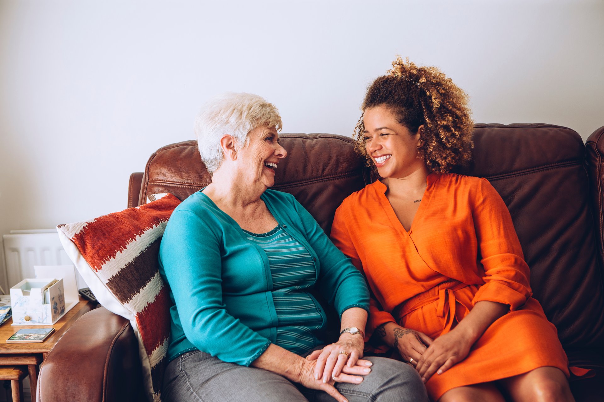 mother and daughter smiling on the couch