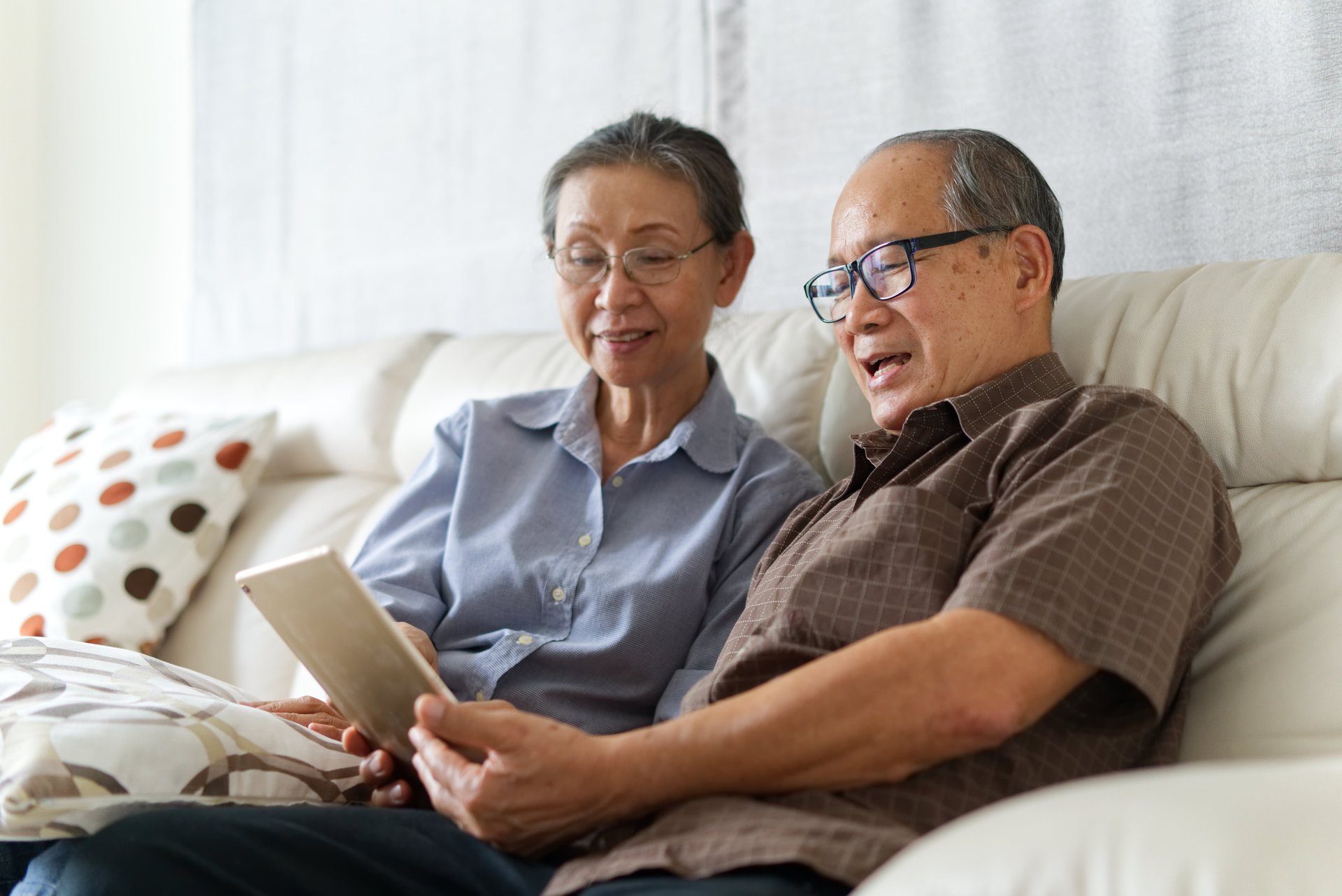 senior couple looking at tablet