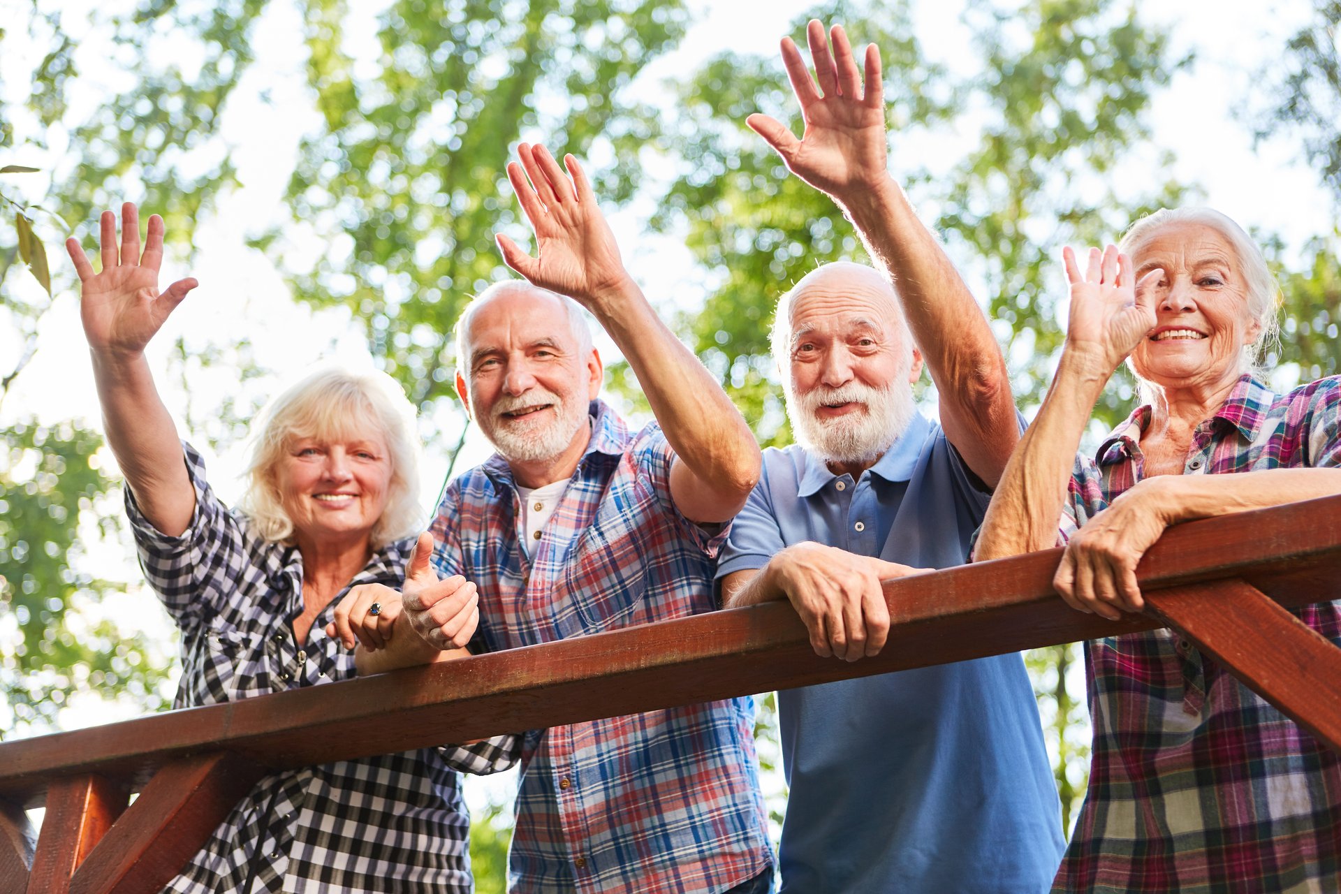 four seniors waving