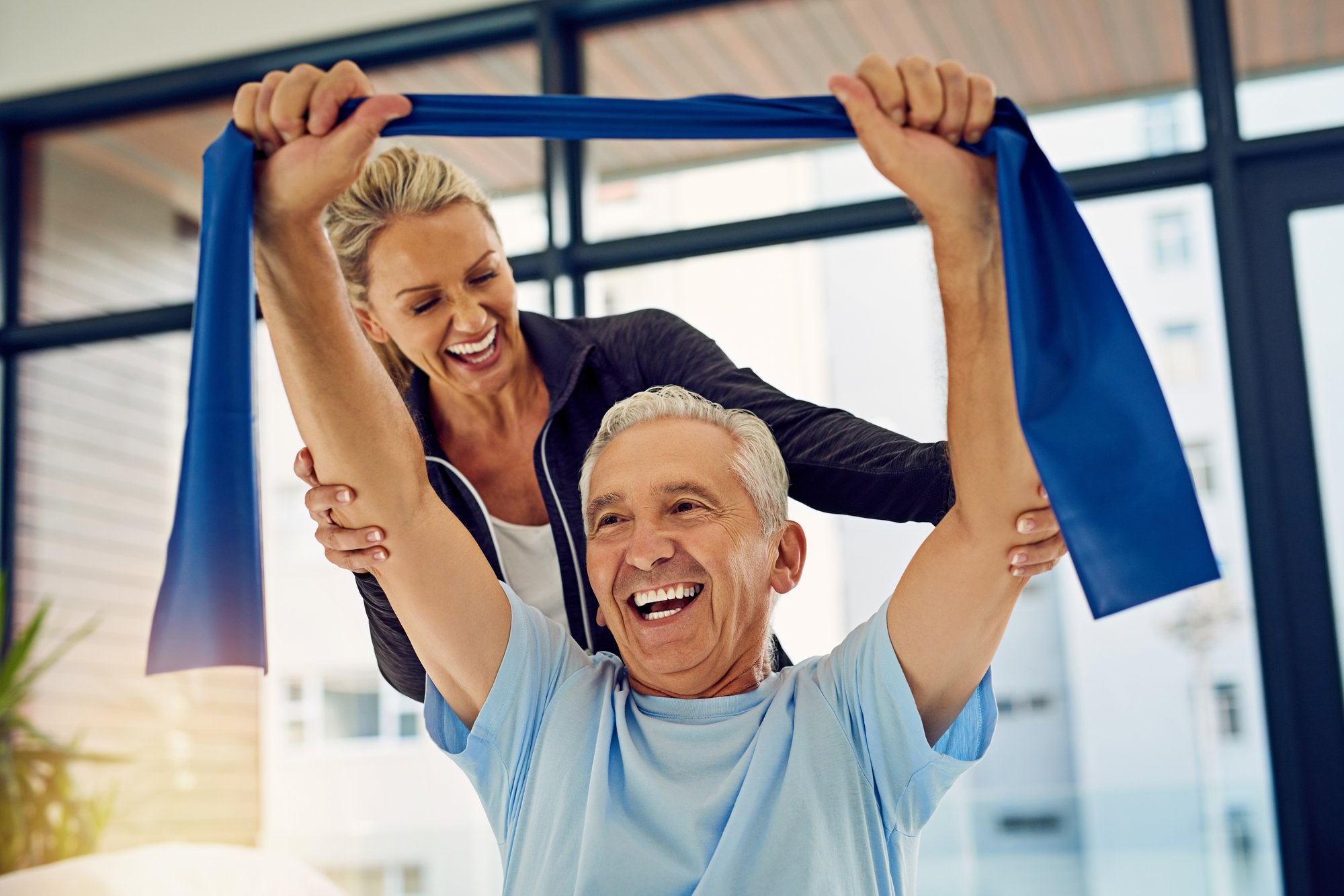 caregiver and senior man working out