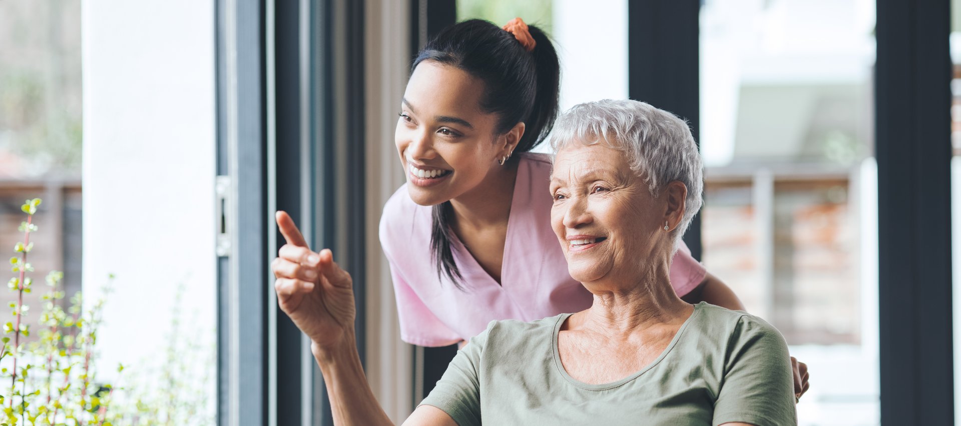 caregiver and senior woman smiling