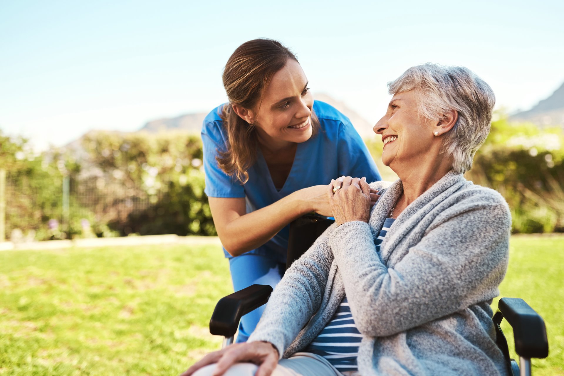 caregiver and senior woman outside