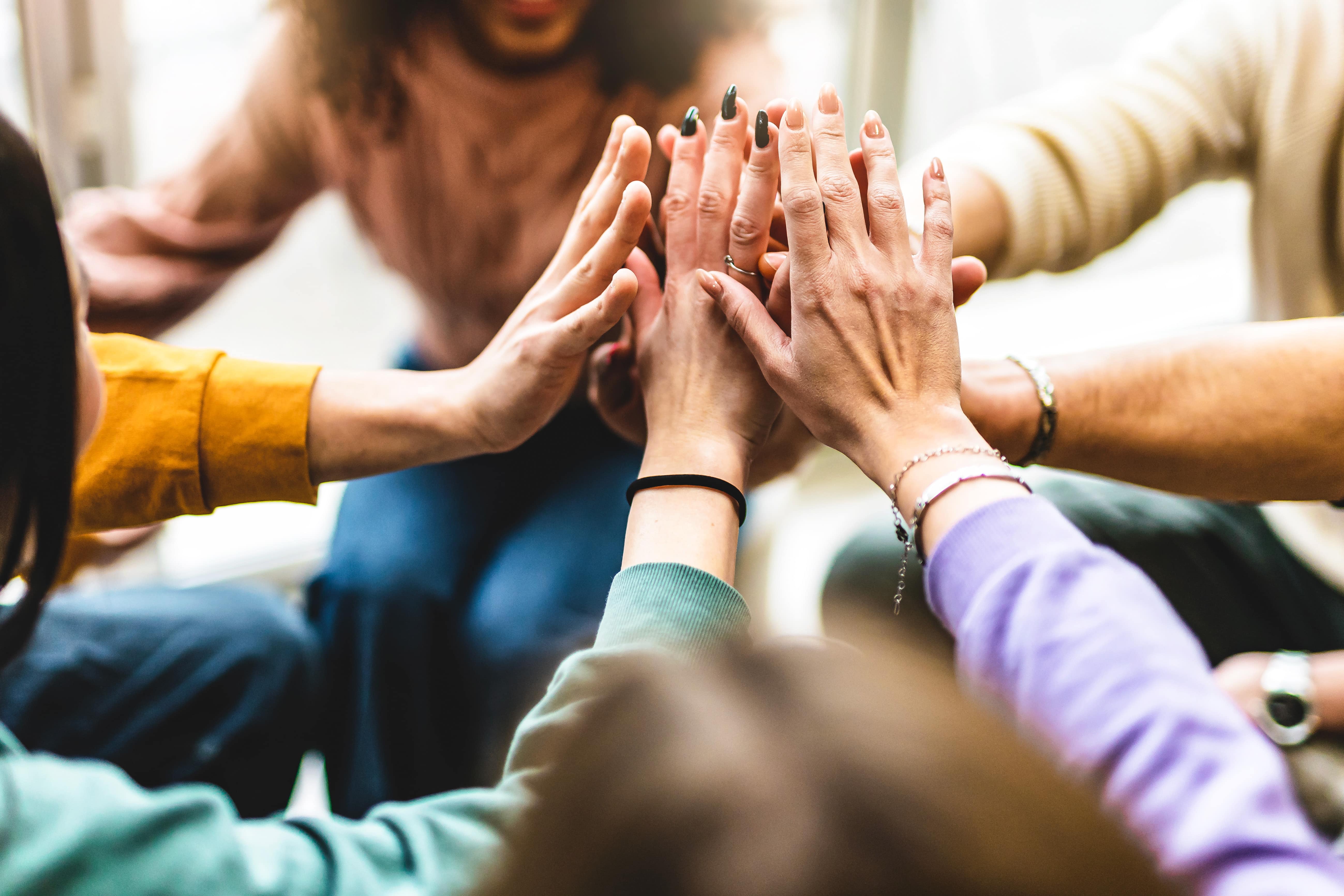 Happy diverse friends united at community table