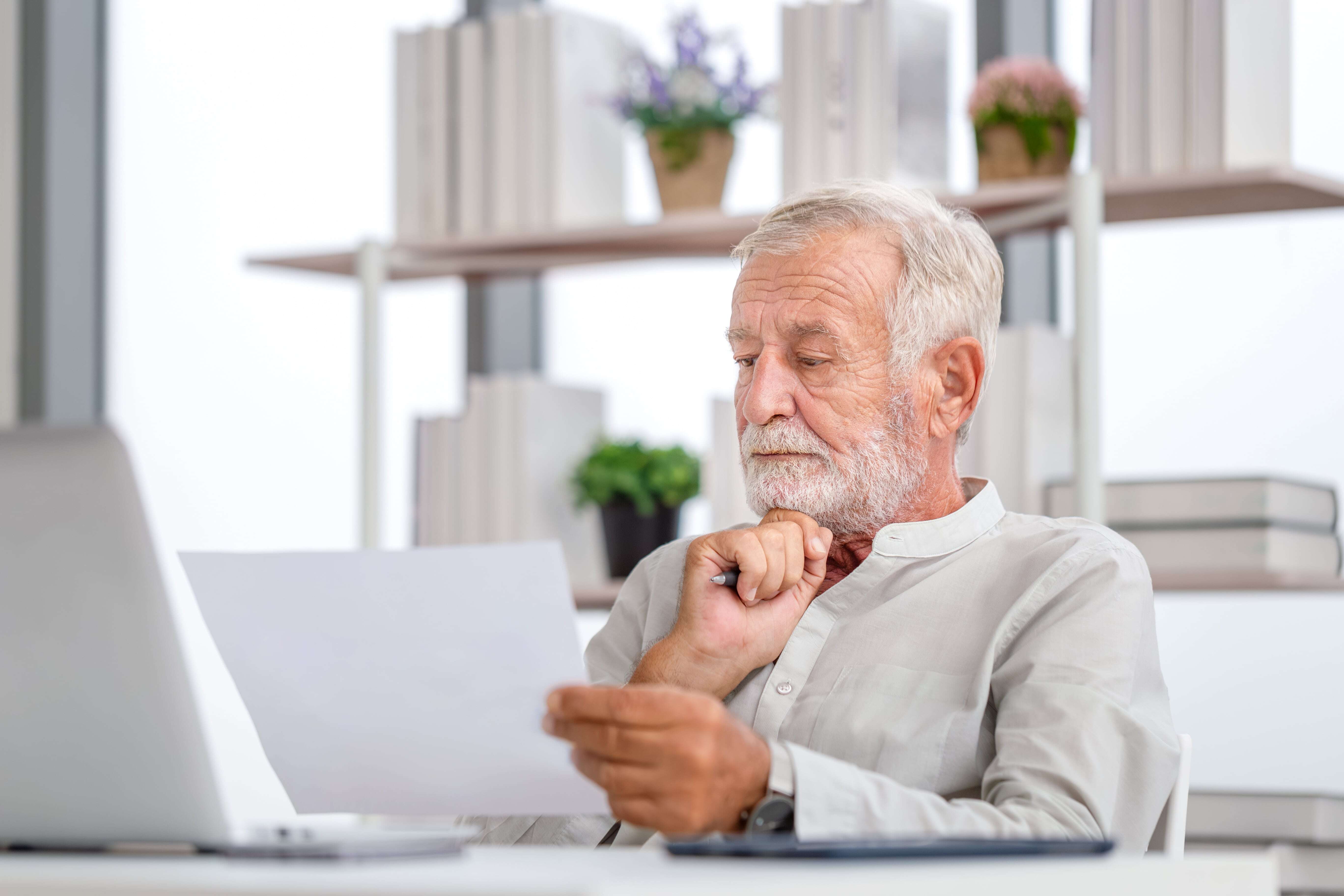 Elder man reading a piece of paper