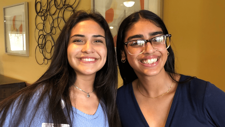 Two team members smiling at the camera