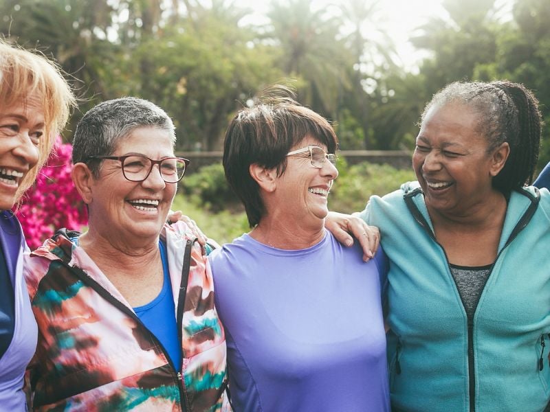 A diverse group of happy older adults laughing together. 