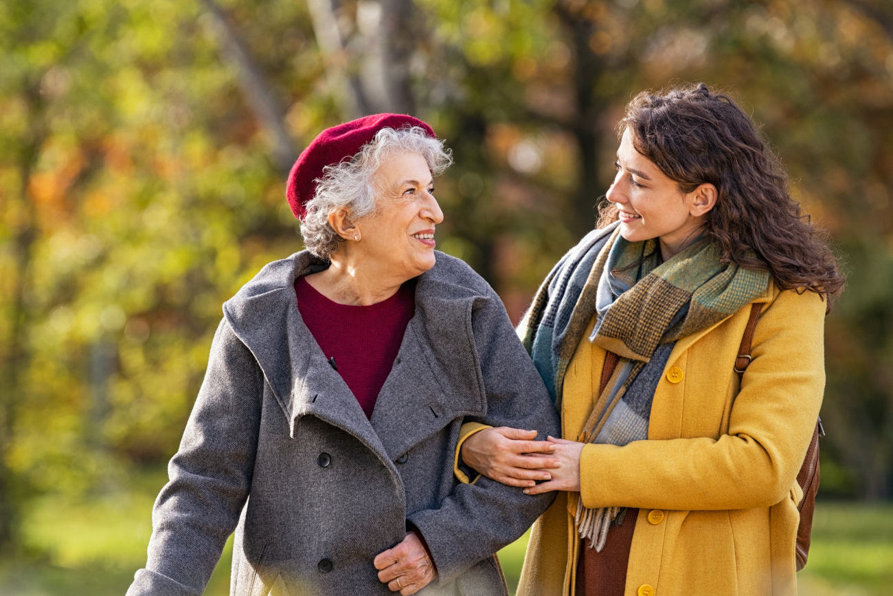 senior and younger woman walking