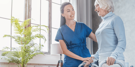 Nurse helping senior walk