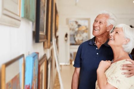 senior couple looking at art