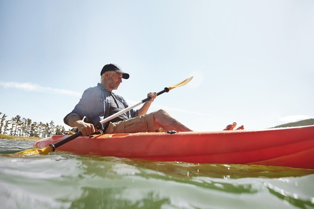 Active senior man kayaking